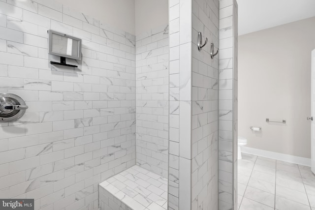 42645 Aden Ter, Ashburn, VA 20148 - bathroom with a tile shower, marble look tile flooring, toilet, and baseboards