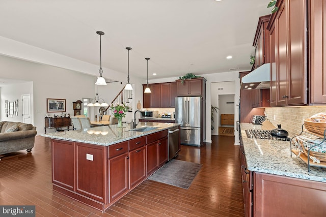 1255 Webb Dr, Perkasie, PA 18944 - kitchen featuring a sink, under cabinet range hood, stainless steel appliances, open floor plan, and decorative backsplash