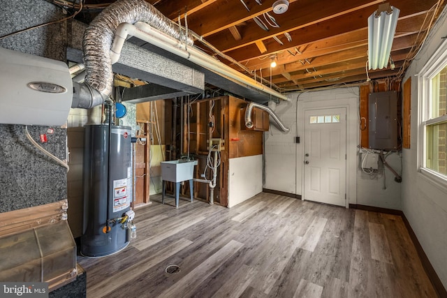 12516 Castleleigh Pl, Silver Spring, MD 20904 - below grade area featuring water heater, electric panel, a sink, wood finished floors, and baseboards