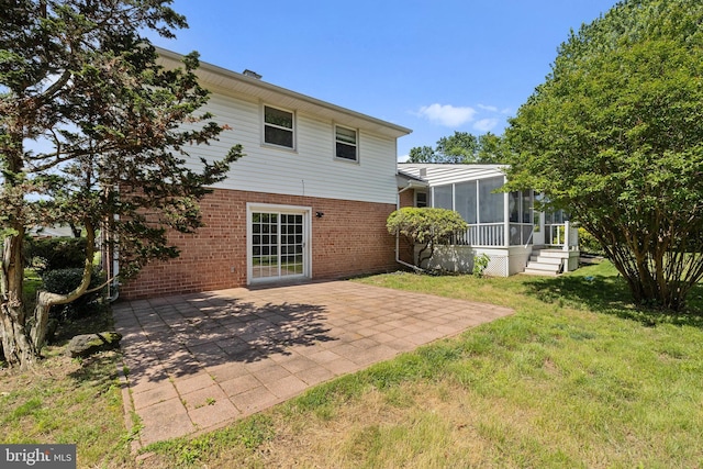 12516 Castleleigh Pl, Silver Spring, MD 20904 - back of house with a sunroom, brick siding, a patio area, and a lawn