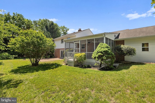 12516 Castleleigh Pl, Silver Spring, MD 20904 - back of property with brick siding, a sunroom, a yard, a chimney, and roof with shingles