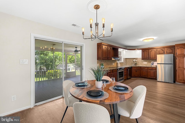 12516 Castleleigh Pl, Silver Spring, MD 20904 - dining room featuring light wood-style flooring, a chandelier, and baseboards