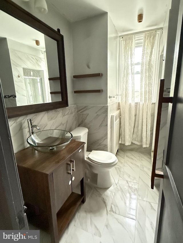 3100 Fanshawe St, Philadelphia, PA 19149 - bathroom with tile walls, vanity, radiator, toilet, and marble finish floors