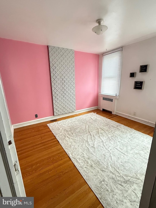 3100 Fanshawe St, Philadelphia, PA 19149 - spare room featuring radiator heating unit, wood finished floors, and baseboards