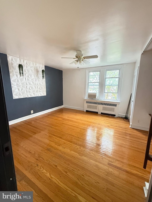 3100 Fanshawe St, Philadelphia, PA 19149 - empty room with radiator, ceiling fan, light wood finished floors, and baseboards