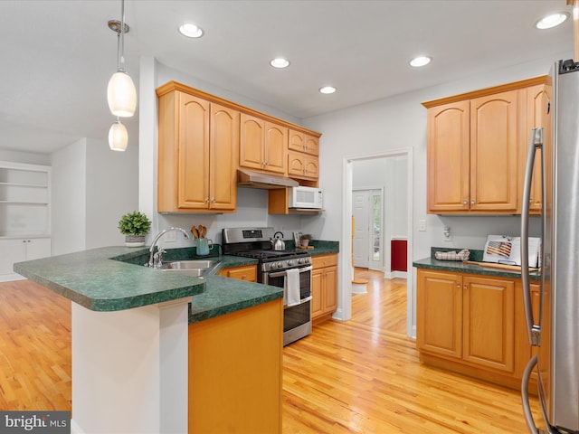 2411 Windwood Dr, Winchester, VA 22601 - kitchen featuring appliances with stainless steel finishes, under cabinet range hood, a peninsula, dark countertops, and light wood-style flooring