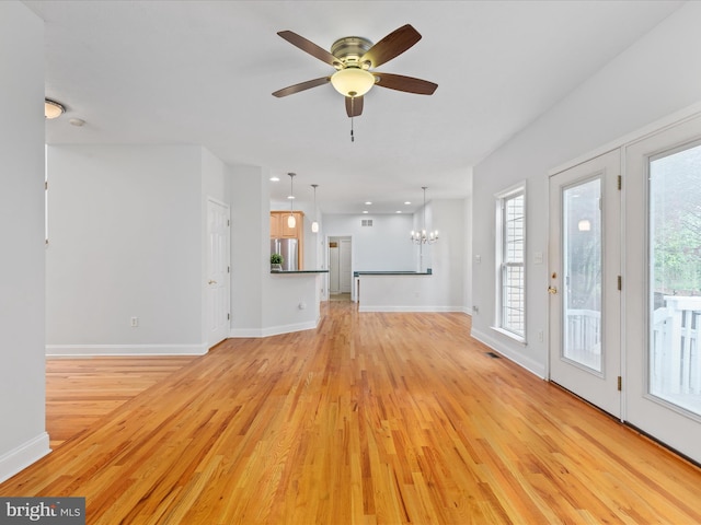 2411 Windwood Dr, Winchester, VA 22601 - unfurnished living room featuring light wood-style flooring and baseboards