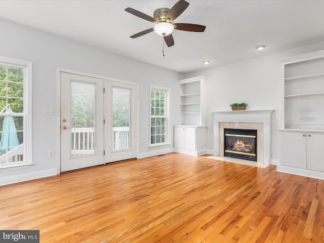 2411 Windwood Dr, Winchester, VA 22601 - unfurnished living room with wood finished floors, built in shelves, baseboards, and a fireplace with flush hearth