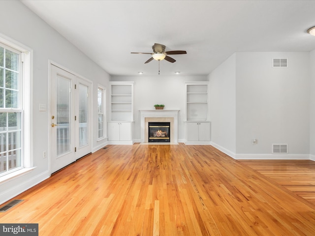 2411 Windwood Dr, Winchester, VA 22601 - unfurnished living room with built in shelves, ceiling fan, baseboards, wood finished floors, and a fireplace with flush hearth