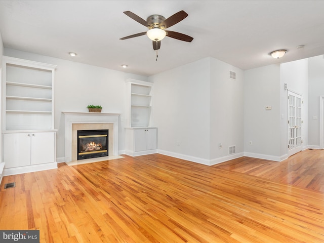 2411 Windwood Dr, Winchester, VA 22601 - unfurnished living room featuring hardwood / wood-style floors, ceiling fan, built in features, a premium fireplace, and baseboards