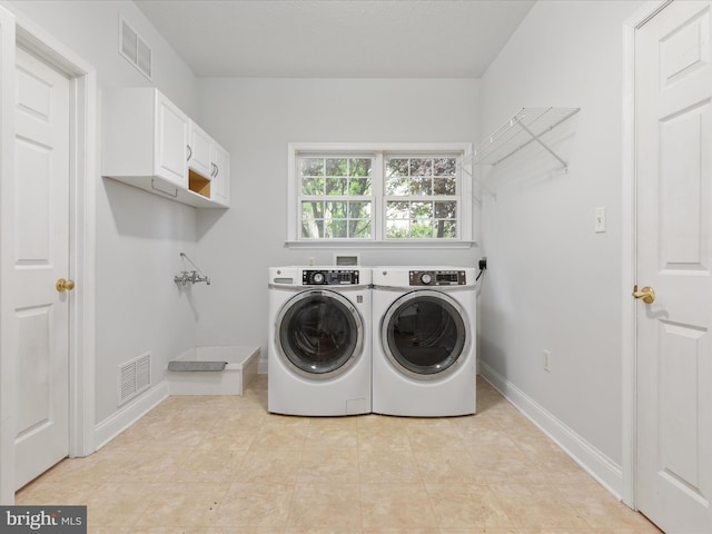 2411 Windwood Dr, Winchester, VA 22601 - laundry area featuring cabinet space, washer and dryer, baseboards, and light tile patterned floors