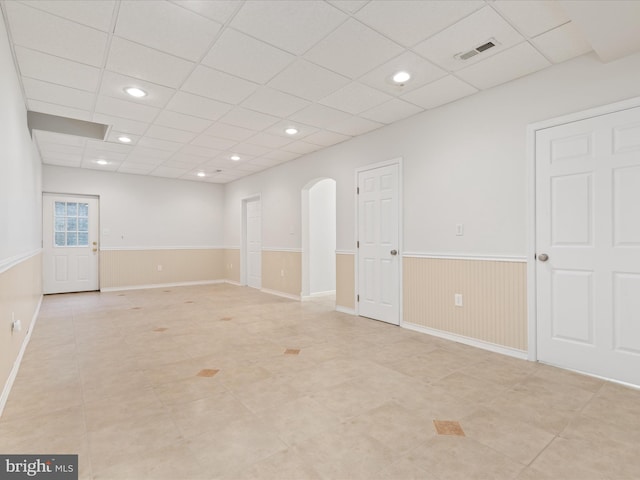 2411 Windwood Dr, Winchester, VA 22601 - empty room with wainscoting, arched walkways, light tile patterned floors, a paneled ceiling, and recessed lighting