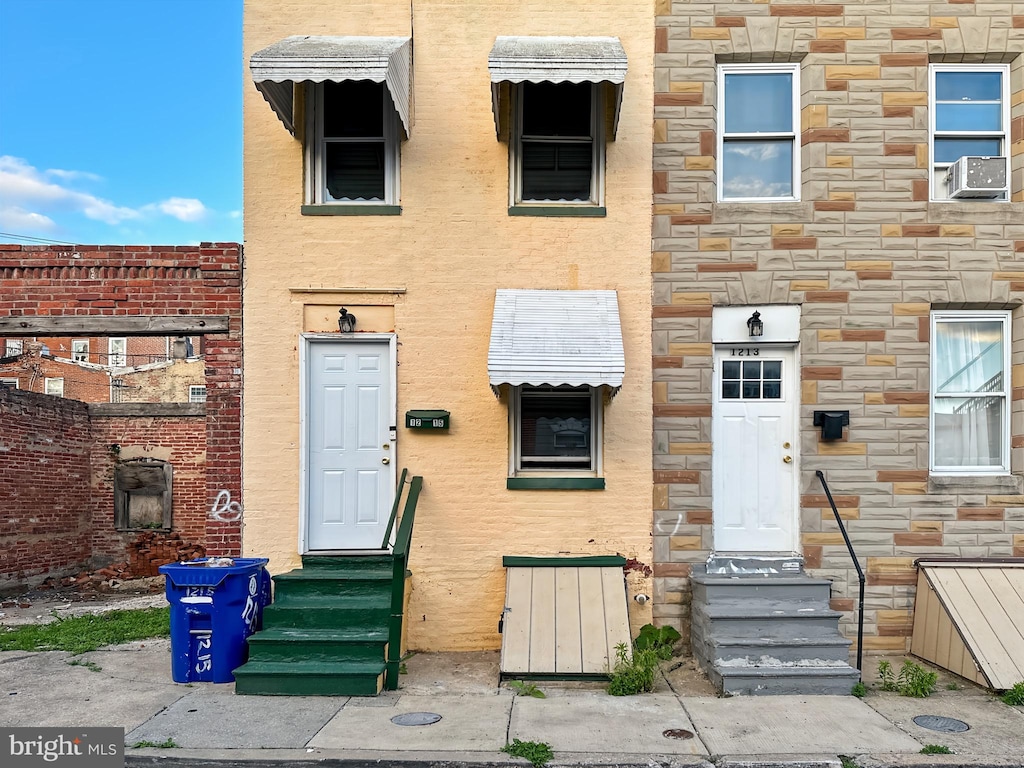 1215 N Spring St, Baltimore, MD 21213 - view of front facade featuring entry steps and stone siding