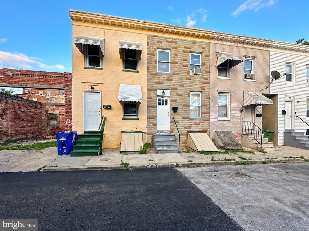 1215 N Spring St, Baltimore, MD 21213 - view of property with entry steps, stone siding, and cooling unit