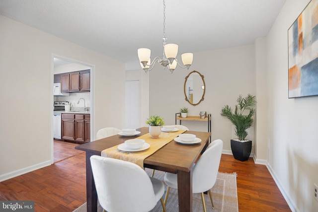 5300 Holmes Run Pkwy Unit 403, Alexandria, VA 22304 - dining area with a chandelier, dark wood-style flooring, and baseboards