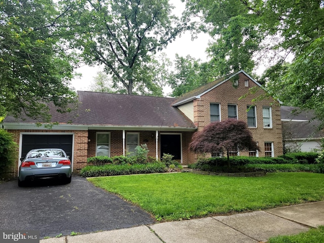 319 Arbor Oaks Ct, Millersville, MD 21108 - view of front of home with an attached garage, brick siding, a front yard, and asphalt driveway