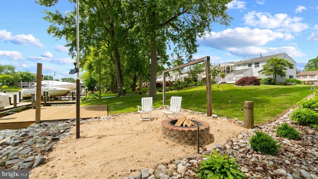 632 Towne Center Dr, Joppa, MD 21085 - view of grassy yard with an outdoor fire pit, a dock, and boat lift