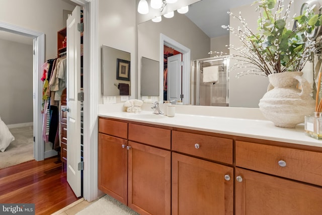 4701 Old Soper Rd Unit 565, Suitland, MD 20746 - full bathroom with a walk in closet, a stall shower, vanity, and wood finished floors