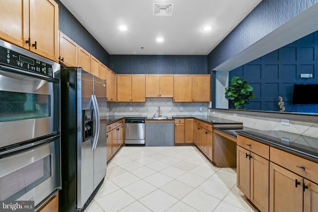 4701 Old Soper Rd Unit 565, Suitland, MD 20746 - kitchen with stainless steel appliances, backsplash, a sink, light tile patterned floors, and recessed lighting