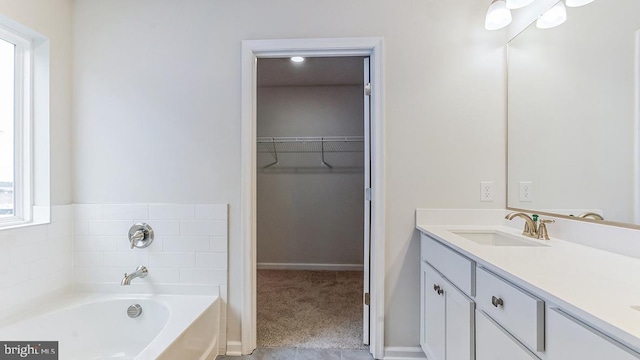 103 New Rd, Tabernacle, NJ 08088 - bathroom featuring a walk in closet, vanity, a garden tub, and baseboards