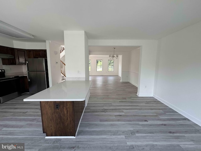 6325 Powder Flask Ct, Centreville, VA 20121 - kitchen featuring stainless steel appliances, a peninsula, under cabinet range hood, light countertops, and a chandelier