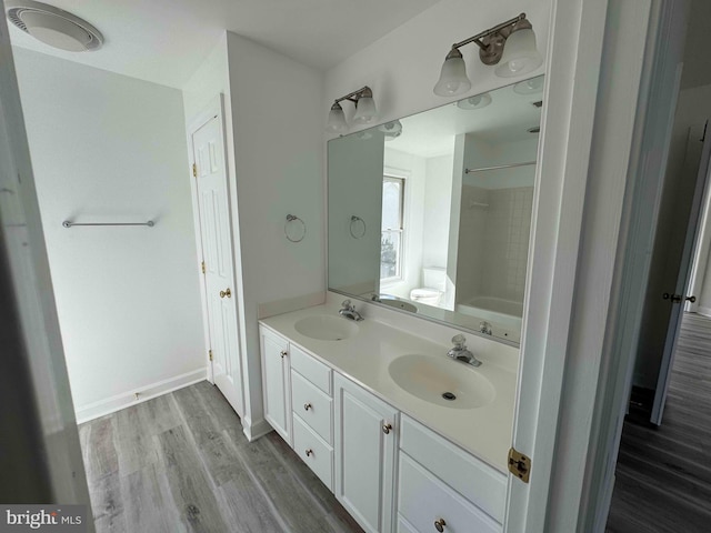 6325 Powder Flask Ct, Centreville, VA 20121 - full bathroom featuring double vanity, wood finished floors, washtub / shower combination, and toilet