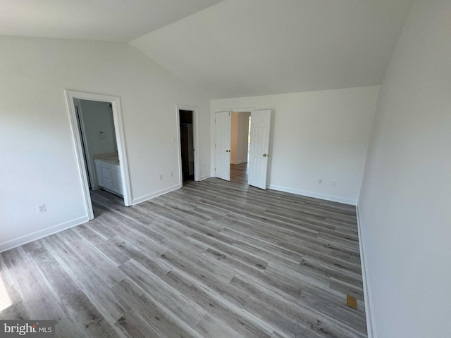 6325 Powder Flask Ct, Centreville, VA 20121 - unfurnished bedroom featuring lofted ceiling, wood finished floors, baseboards, and connected bathroom