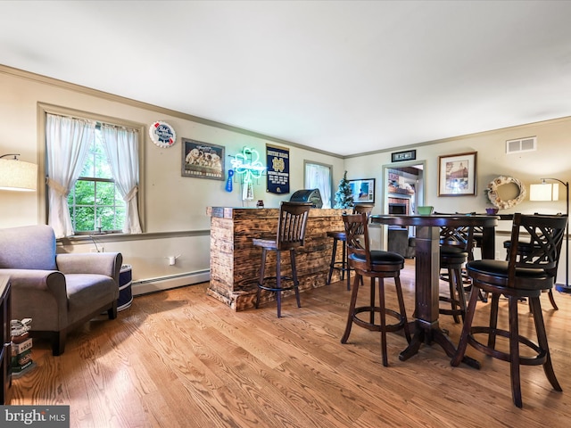3622 Pricetown Rd, Fleetwood, PA 19522 - indoor dry bar featuring a baseboard heating unit, ornamental molding, wood finished floors, and baseboards