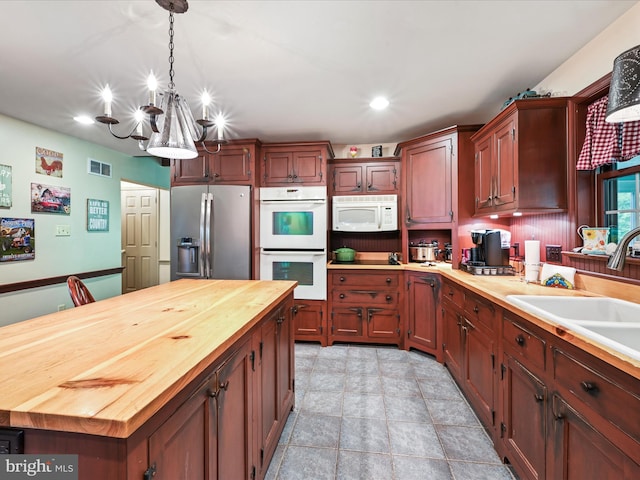 3622 Pricetown Rd, Fleetwood, PA 19522 - kitchen with white appliances, butcher block counters, a chandelier, recessed lighting, and decorative light fixtures