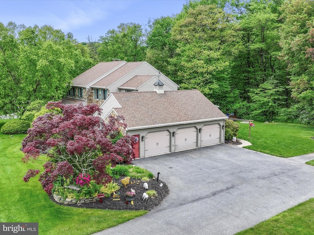 3622 Pricetown Rd, Fleetwood, PA 19522 - view of property exterior featuring a garage, a shingled roof, asphalt driveway, a lawn, and a forest view