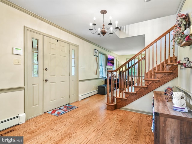 3622 Pricetown Rd, Fleetwood, PA 19522 - entrance foyer featuring baseboard heating, wood finished floors, a chandelier, stairway, and ornamental molding