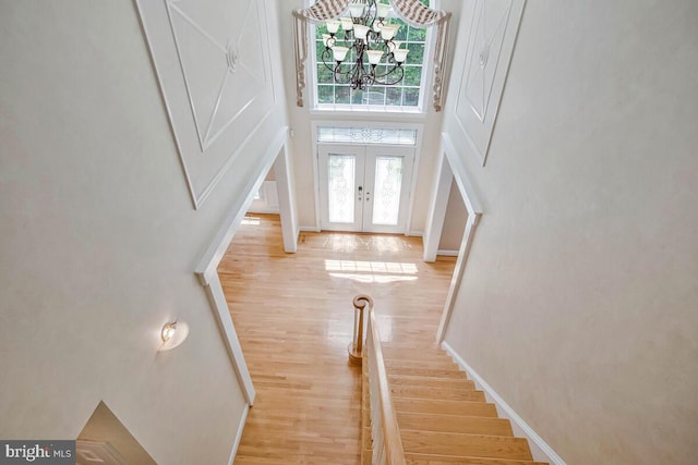 5257 Ferry Branch Ln, Lothian, MD 20711 - foyer with light wood-style flooring, a towering ceiling, a chandelier, baseboards, and stairway