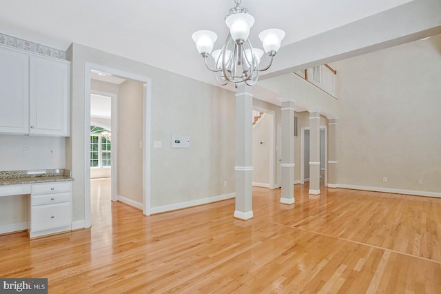 5257 Ferry Branch Ln, Lothian, MD 20711 - unfurnished dining area with light wood finished floors, a chandelier, baseboards, and stairway