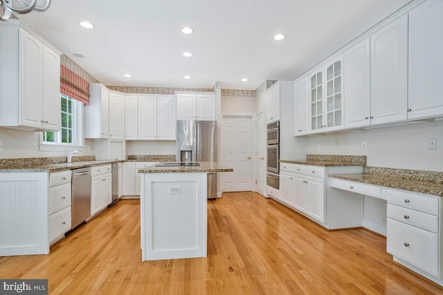 5257 Ferry Branch Ln, Lothian, MD 20711 - kitchen featuring a warming drawer, stainless steel appliances, a center island, glass insert cabinets, and white cabinetry