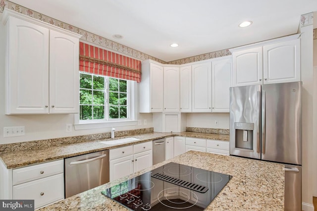 5257 Ferry Branch Ln, Lothian, MD 20711 - kitchen featuring appliances with stainless steel finishes, a sink, white cabinets, light stone countertops, and recessed lighting