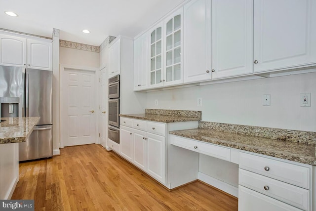 5257 Ferry Branch Ln, Lothian, MD 20711 - kitchen with stainless steel appliances, a warming drawer, light wood finished floors, white cabinetry, and recessed lighting