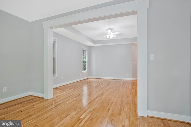 5257 Ferry Branch Ln, Lothian, MD 20711 - empty room with baseboards, light wood-style floors, a ceiling fan, and a raised ceiling
