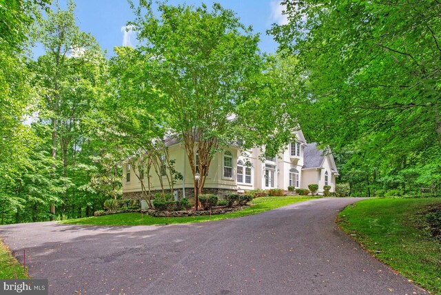 5257 Ferry Branch Ln, Lothian, MD 20711 - view of front of home featuring stucco siding, asphalt driveway, and a front yard