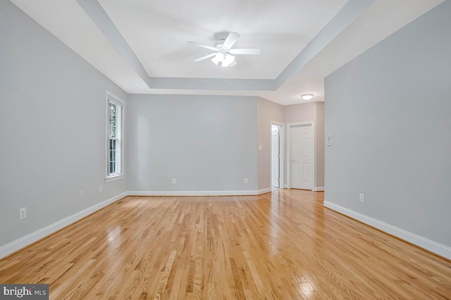 5257 Ferry Branch Ln, Lothian, MD 20711 - unfurnished room with a raised ceiling, a ceiling fan, baseboards, and light wood-style floors