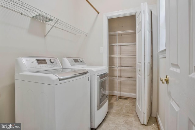 5257 Ferry Branch Ln, Lothian, MD 20711 - laundry room featuring washer and clothes dryer and baseboards