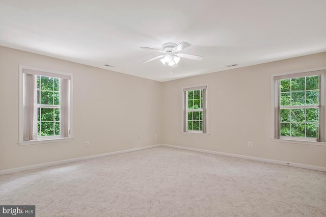 5257 Ferry Branch Ln, Lothian, MD 20711 - empty room with plenty of natural light, ceiling fan, baseboards, and light carpet