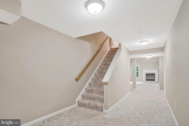 5257 Ferry Branch Ln, Lothian, MD 20711 - staircase with carpet flooring, baseboards, and a glass covered fireplace
