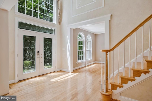 5257 Ferry Branch Ln, Lothian, MD 20711 - foyer with stairway, a high ceiling, wood finished floors, french doors, and baseboards
