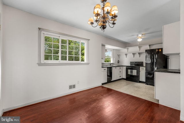 807 Fulton Pl, Woodbridge, VA 22191 - kitchen with black appliances, dark countertops, wood finished floors, a chandelier, and a ceiling fan