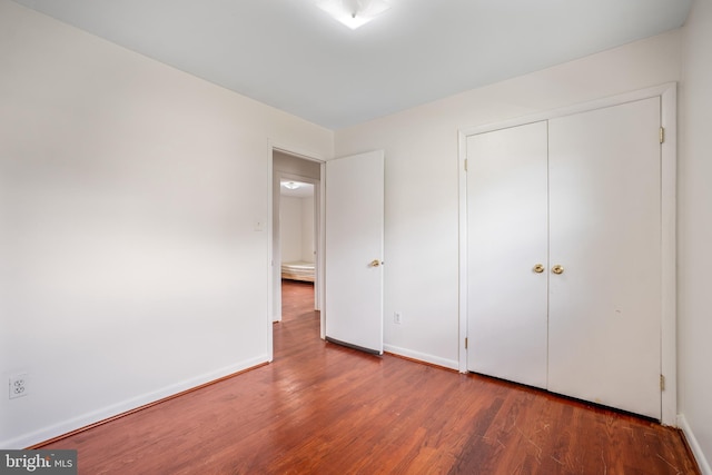 807 Fulton Pl, Woodbridge, VA 22191 - unfurnished bedroom with wood finished floors, baseboards, and a closet