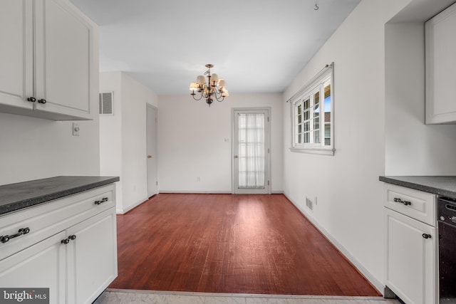 807 Fulton Pl, Woodbridge, VA 22191 - kitchen featuring dark countertops, a chandelier, and white cabinets