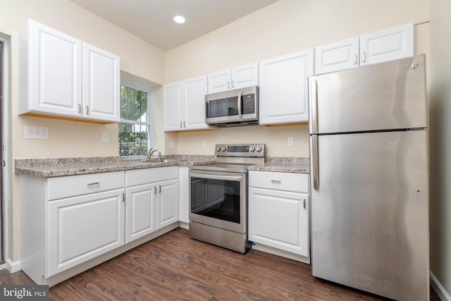 1839 Ramsay St, Baltimore, MD 21223 - kitchen featuring appliances with stainless steel finishes, dark wood finished floors, white cabinets, a sink, and recessed lighting