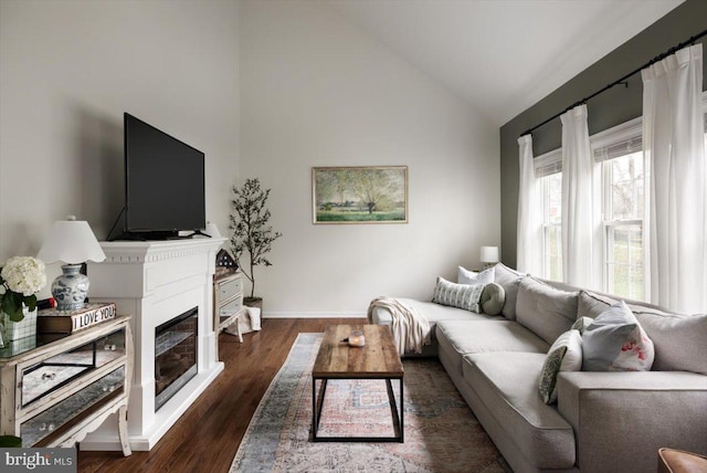 47 Orleans Dr, Shepherdstown, WV 25443 - living area featuring vaulted ceiling, a glass covered fireplace, baseboards, and wood finished floors