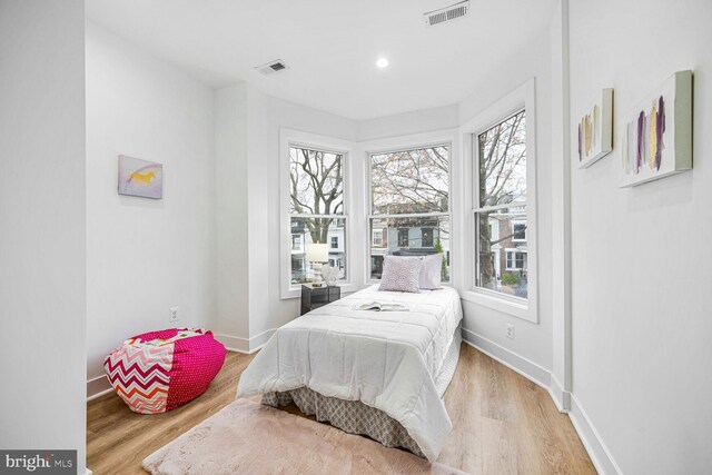 bedroom featuring baseboards and wood finished floors