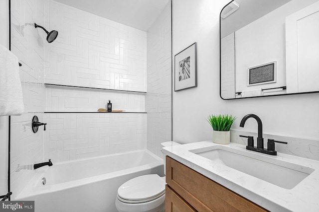 bathroom with toilet, vanity, and shower / washtub combination